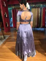 Side view of a model showcasing Lilac Silk Lehenga Set (Set of 2), Appropriate for major Hindu celebrations like Durga Puja and Navratri By Mirra Clothing
