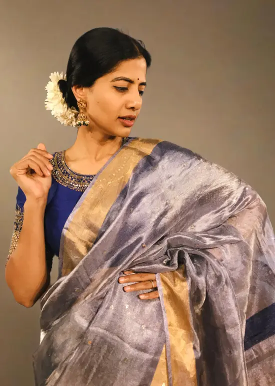 Close up view of a model showcasing Blue Tissue Silk Saree, designed for elegance at any party By Mirra Clothing