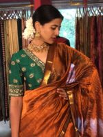 Front view of a model showcasing a Honey Orange Mangalagiri Silk Saree Handwoven in Gold Zari Chequered Pattern, Suitable For Weddings & Receptions