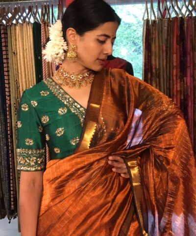 Front view of a model showcasing a Honey Orange Mangalagiri Silk Saree Handwoven in Gold Zari Chequered Pattern, Suitable For Weddings & Receptions