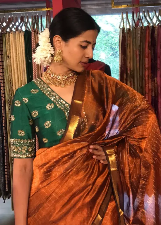 Front view of a model showcasing a Honey Orange Mangalagiri Silk Saree Handwoven in Gold Zari Chequered Pattern, Suitable For Weddings & Receptions