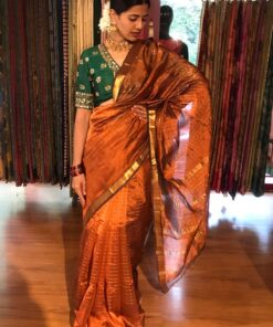 Full view of a model showcasing Honey Orange Mangalagiri Silk Saree Handwoven in Gold Zari Chequered Pattern, Suitable For Festivals & Religious Celebrations By Mirra Clothing