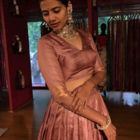 A side view of a model wearing a Tussar Silk Lehenga suitable for Party wear and festive by Mirra Clothing