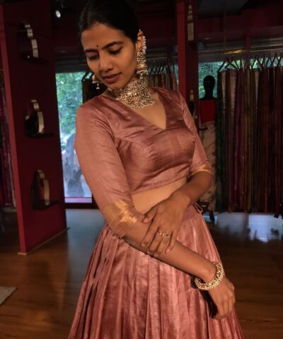 A side view of a model wearing a Tussar Silk Lehenga suitable for Party wear and festive by Mirra Clothing