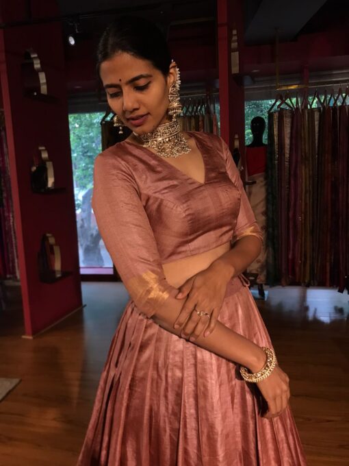 A side view of a model wearing a Tussar Silk Lehenga suitable for Party wear and festive by Mirra Clothing