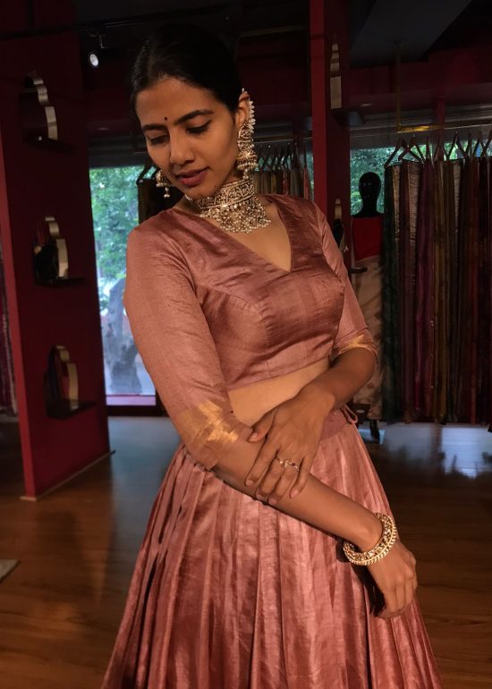 A side view of a model wearing a Tussar Silk Lehenga suitable for Party wear and festive by Mirra Clothing
