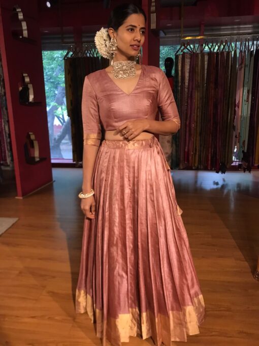 A Full view of a model showcasing a Dusty Pink Tussar Lehenga suitable for Casual wear