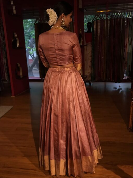 A Back Full View of a model wearing a Dusty Pink Tussar Silk Lehenga suitable for Birthday parties