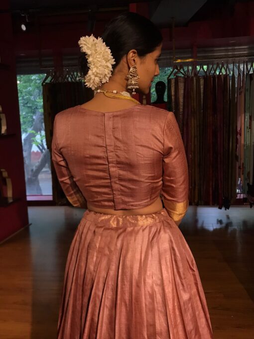 Close up back view of a model wearing a dusty Pink Tussar Lehenga suitable for poojas