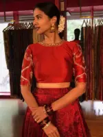 Close up image of model wearing a maroon embroidered lehenga set suitable for wedding by mirra clothing