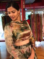 A model wearing Bottle Green Printed Tissue Silk Lehenga it can wear for wedding festival by mirra clothing