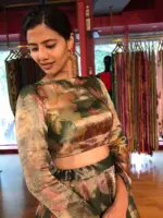 A model wearing Bottle Green Printed Tissue Silk Lehenga it can wear for wedding festival by mirra clothing