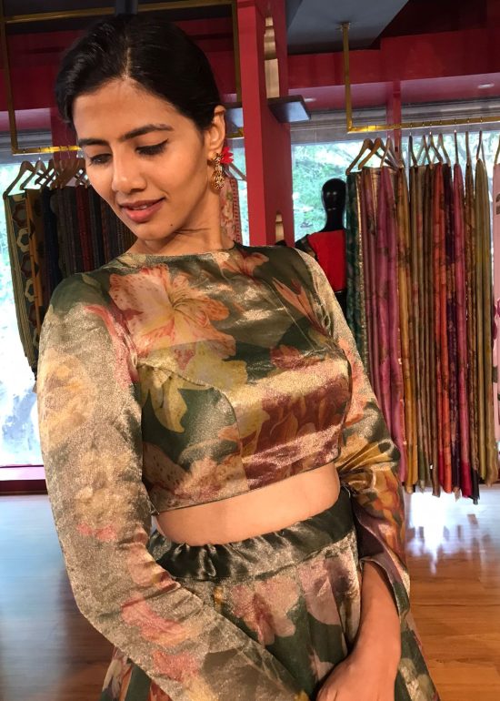 A model wearing Bottle Green Printed Tissue Silk Lehenga it can wear for wedding festival by mirra clothing