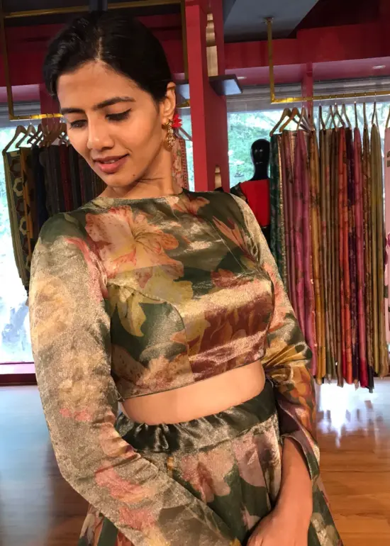 A model wearing Bottle Green Printed Tissue Silk Lehenga it can wear for wedding festival by mirra clothing
